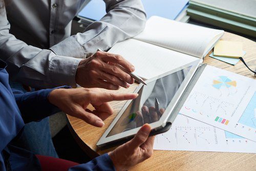 Picture of two people discussing on tablet