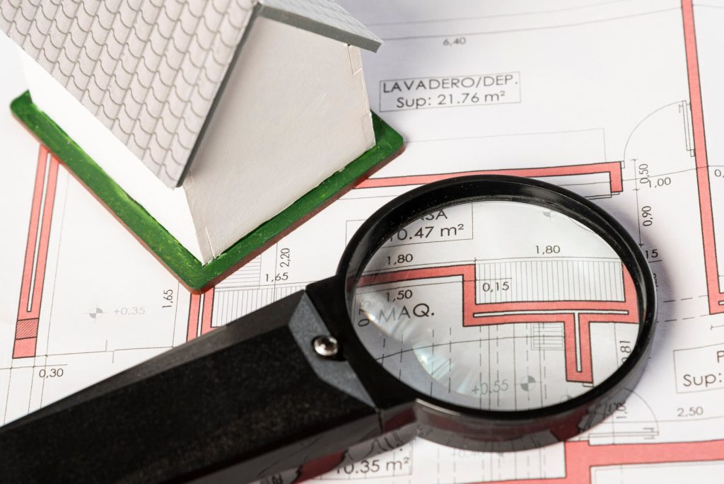 high view real estate plans with a magnifying glass for surveying services